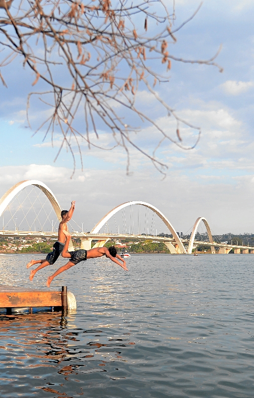 No Lago Paranoá, os dois jovens não hesitaram em dar um mergulho. E não era para menos. Os brasilienses enfrentaram ontem o dia mais quente do ano no Distrito Federal: os termômetros cravaram 34,6ºC à tarde, enquanto a umidade relativa do ar descia a 13%, na mínima. O Instituto Nacional de Meteorologia (Inmet) emitiu alerta laranja, o que significa risco em potencial à saúde. Moradora do Jardim Botânico, Maria Cleonice de Souza, 61 anos, sofre com o tempo seco. %u201CEu me sinto mal. Minha pressão até cai%u201D, relata a aposentada. A boa notícia, segundo o Inmet, é que uma frente fria vinda do Sul pode provocar chuvas rápidas amanhã na capital. Para hoje, contudo, a previsão é de mais um dia de forte calor, com a temperatura alcançando 34%, na máxima, e a umidade relativa do ar entre 50% e 15%.  (Ed Alves/CB/D.A Press)